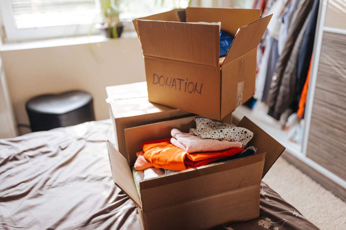 Boxes with clothes for donation in home interior