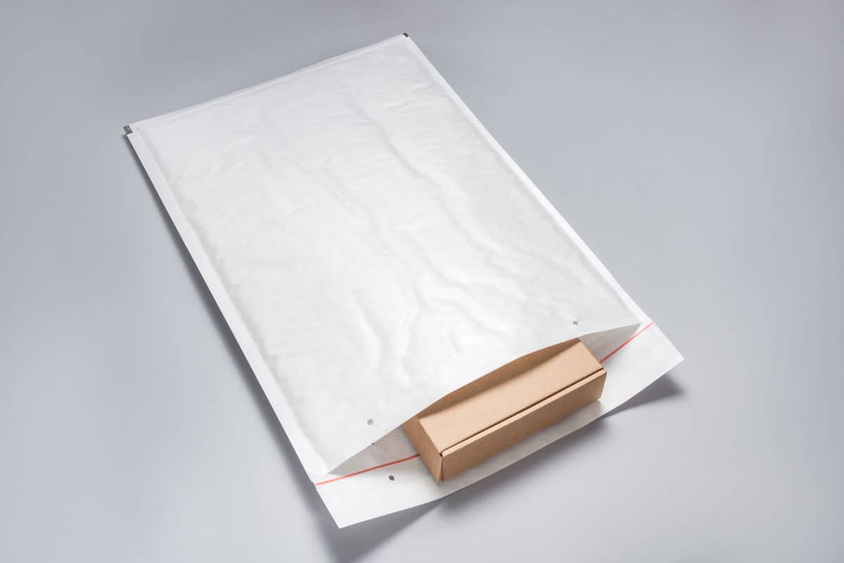 Brown cardboard box packed in white bubble envelopes