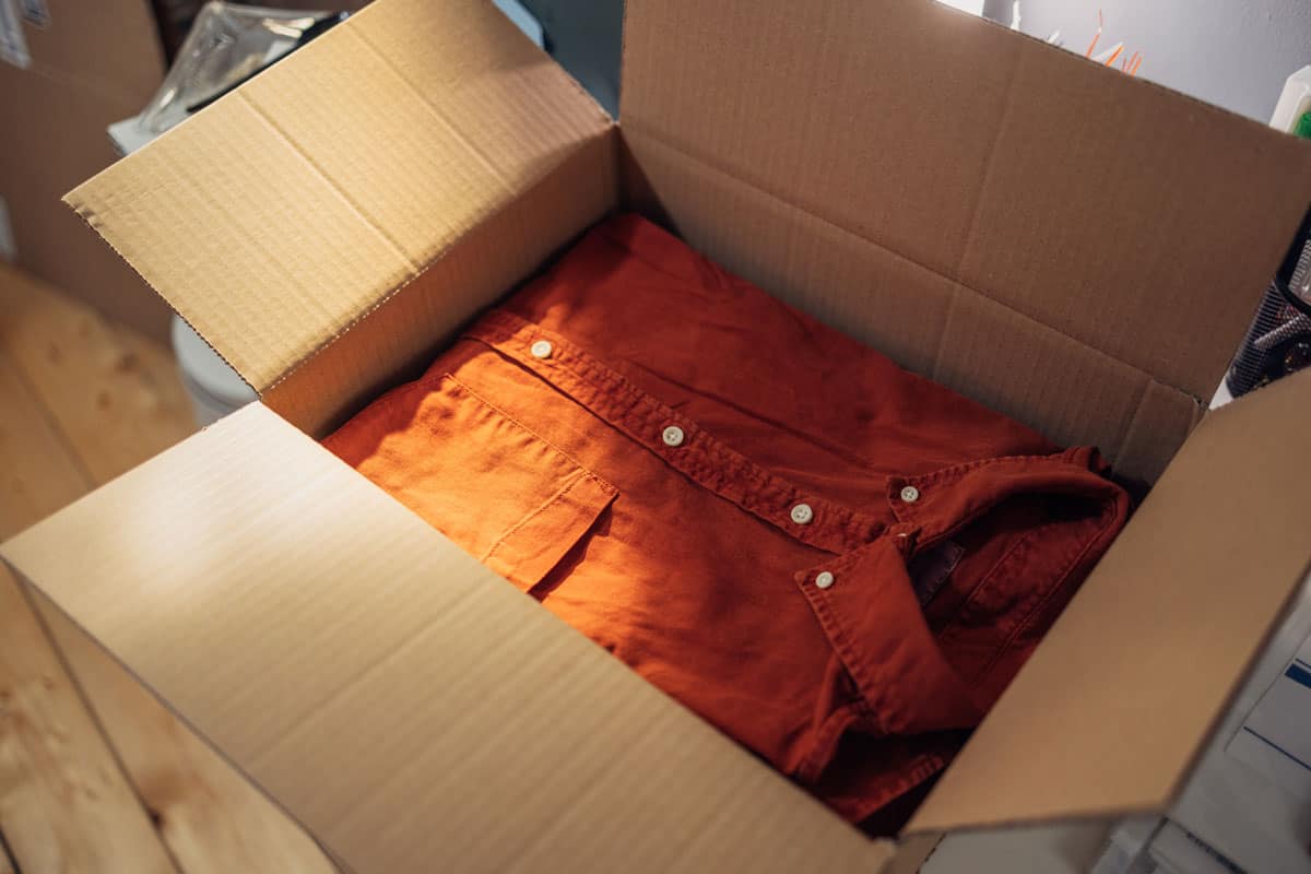 Clothes packed in a cardboard box for shipping