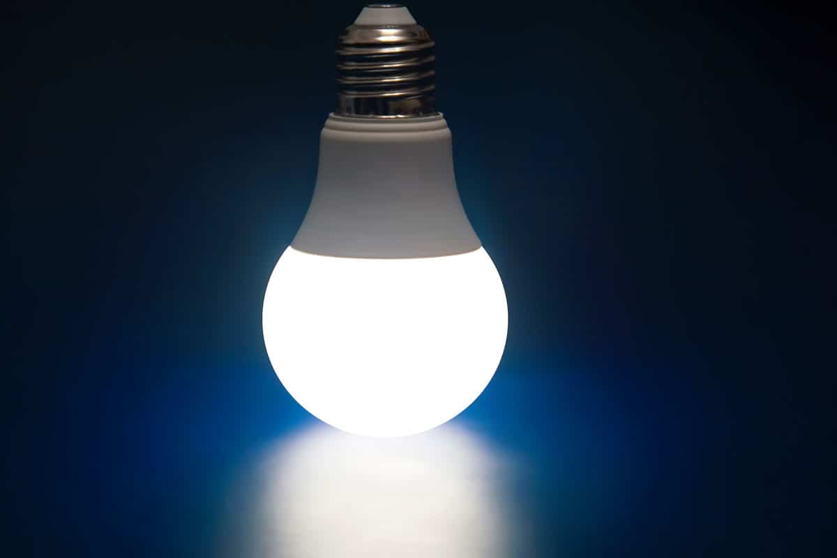 Glowing LED lamp on a dark blue
