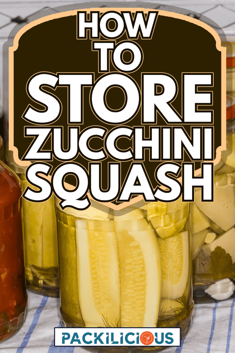 Home canned zucchini and vegetable marrow with spices in glass jars on a napkin on kitchen table, close-up - How To Store Zucchini Squash