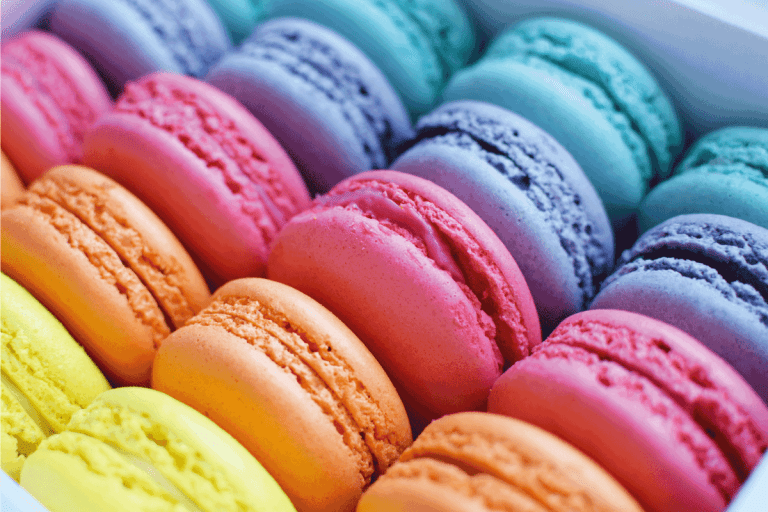Multicolored rainbow macaroon desserts. Delicious french macaroons with filling. How To Pack And Ship Macarons [And How Long Will They Last]?