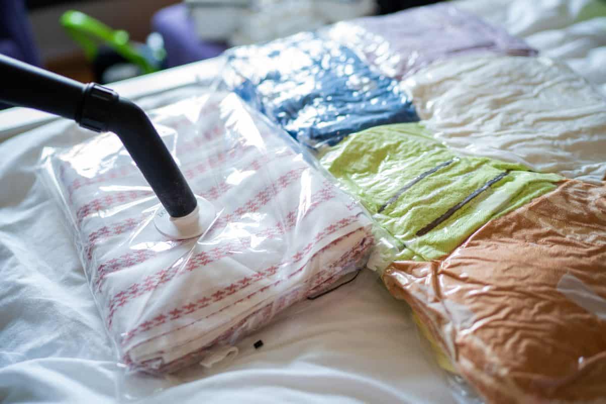 Packing clothes, towels and bed sheets in a vacuum bags

