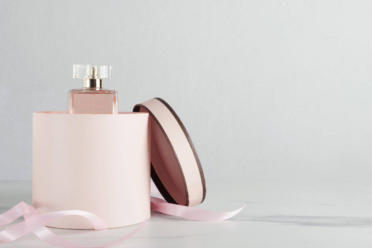 Perfume for woman in the opened pink box.Concept of gift for woman.