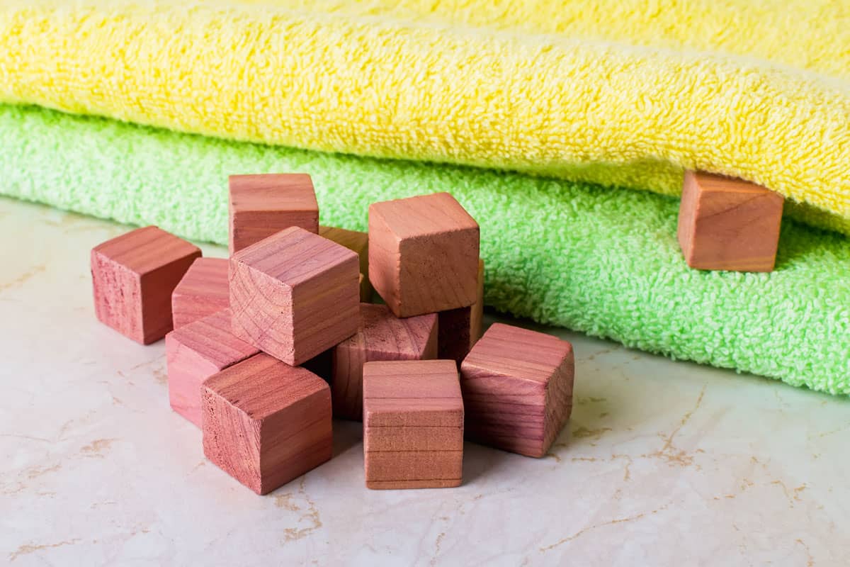 Scented wooden cubes near two bath towels