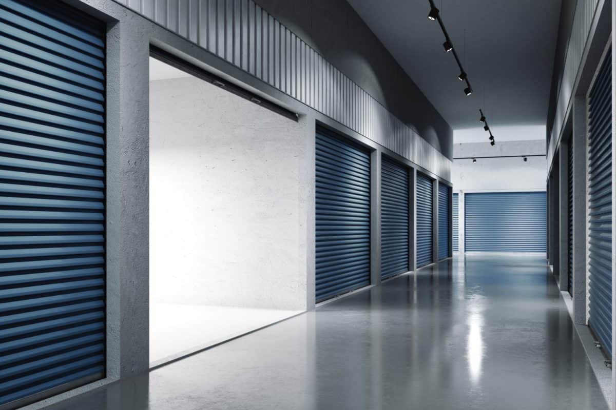Storage facilities with blue doors. Opened door. Light inside