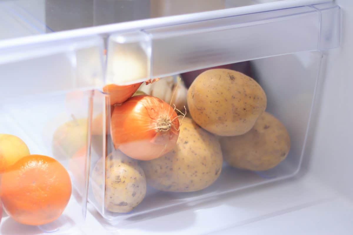 Vegetables in the open fridge drawer
