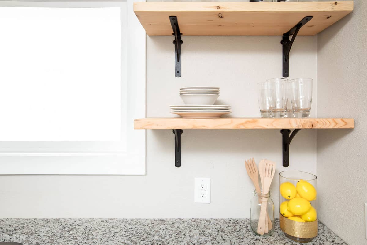 Wooden floating shelves in a modern kitchen space