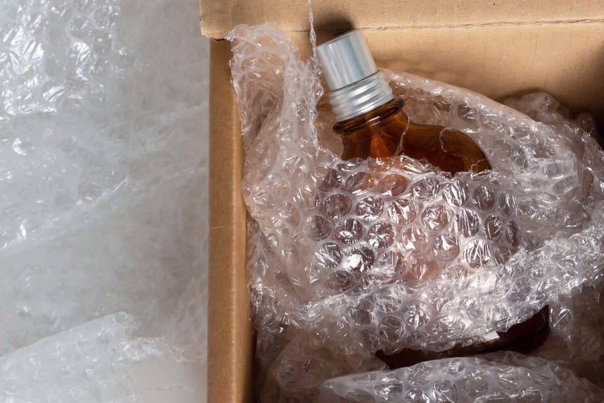 bottle of eau de toilette in a cardboard box and soft bubble wrap for safe shipment


