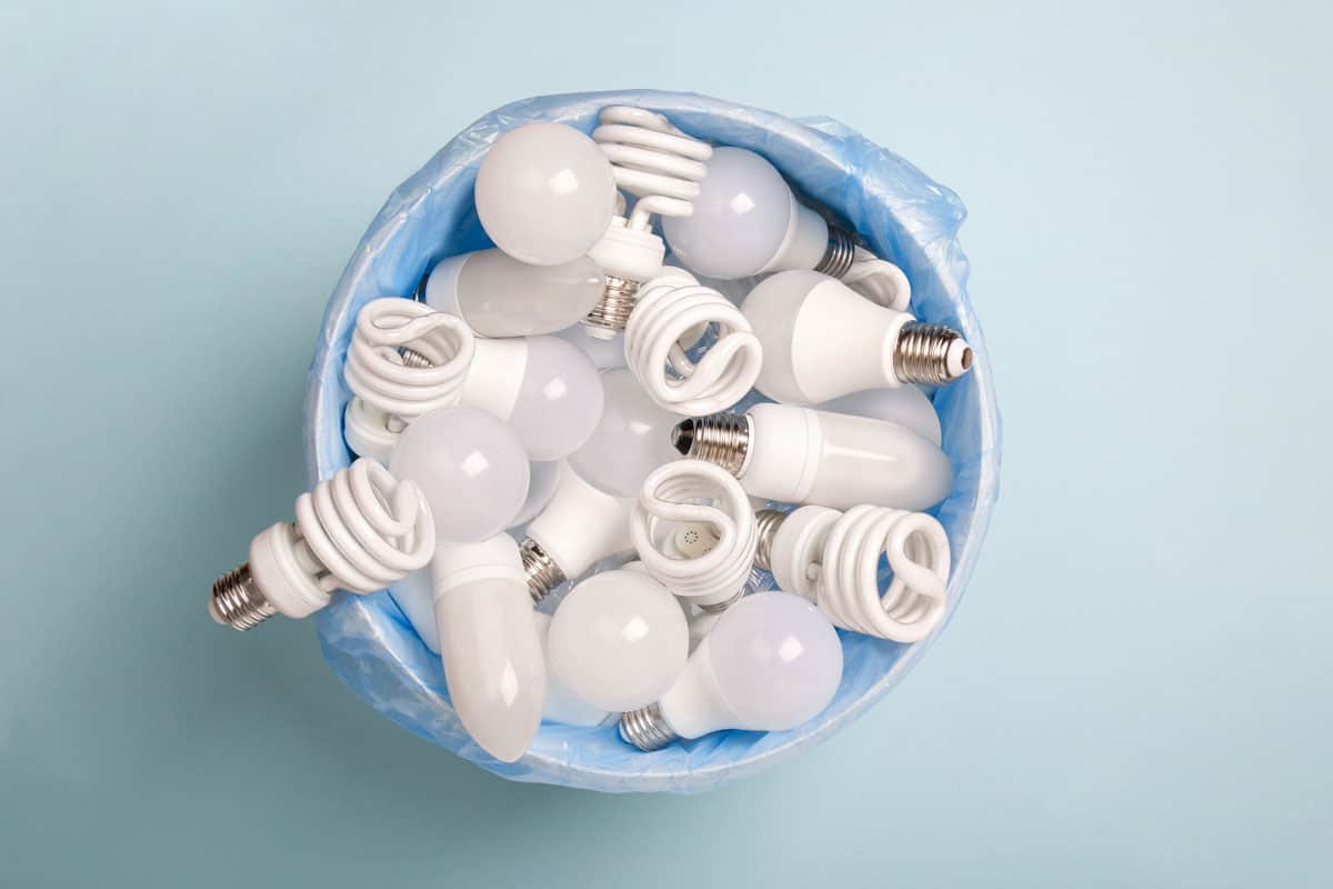 energy saving light bulbs in a bucket in disposable plastic garbage bag