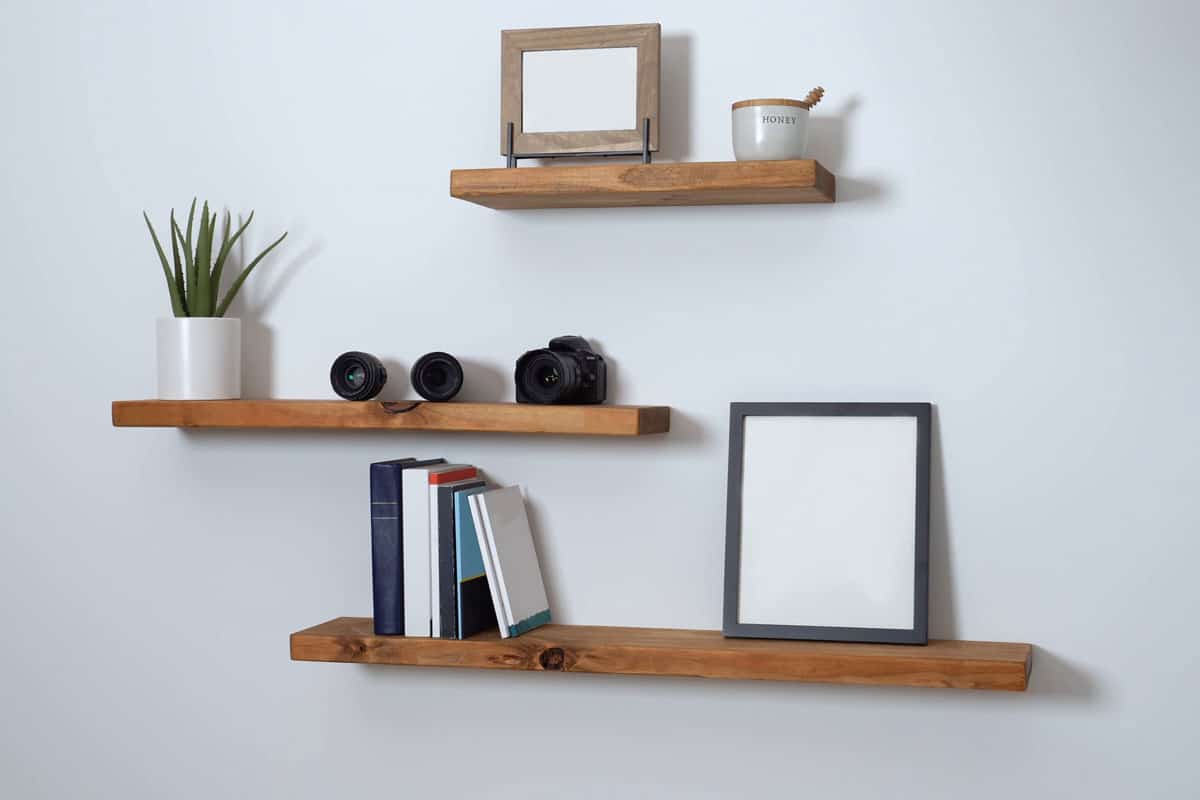 minimalist floating shelf made of wood with books