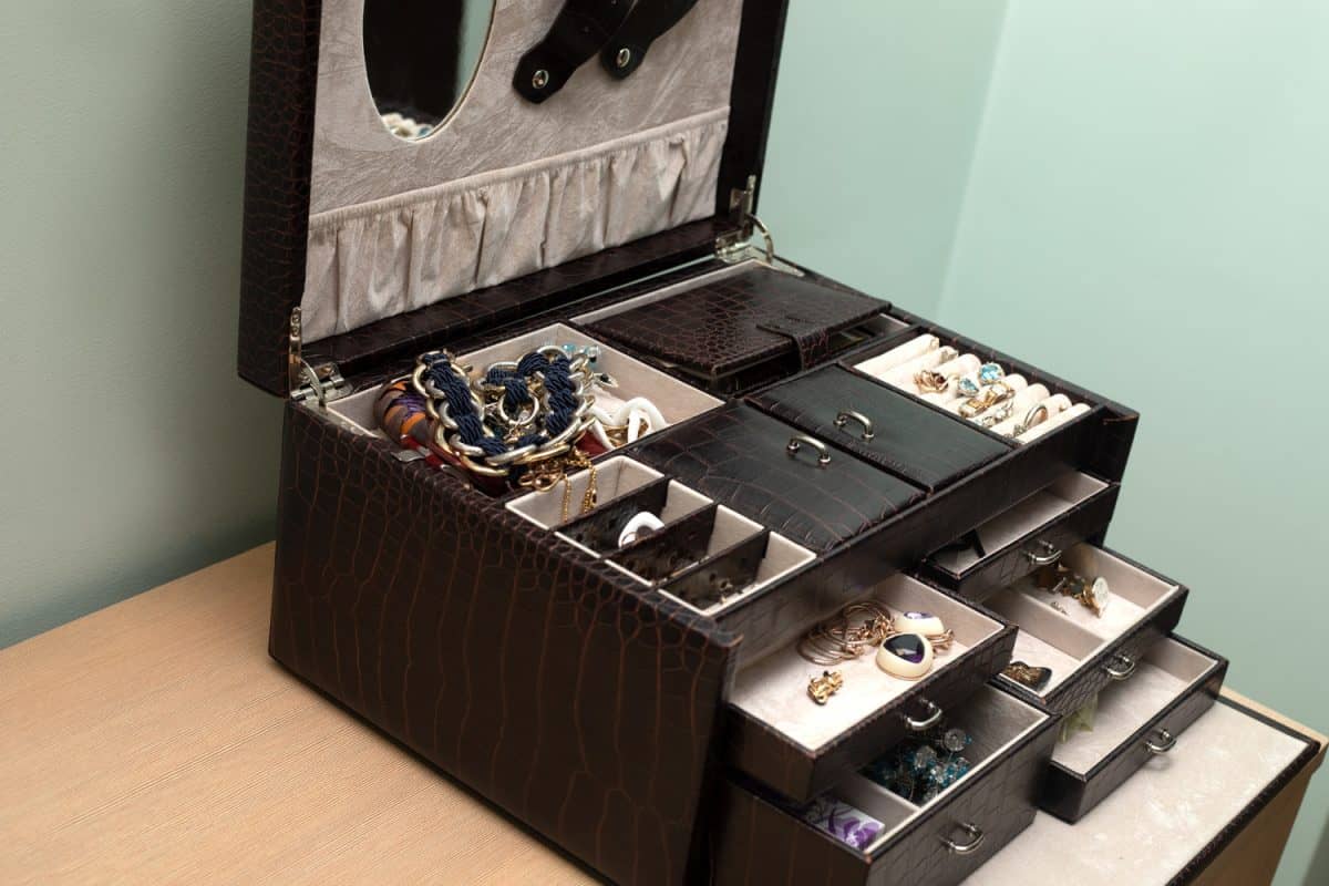 Box for storing jewelry made of cracodile skin in interior of room. Personal Organizer open.

