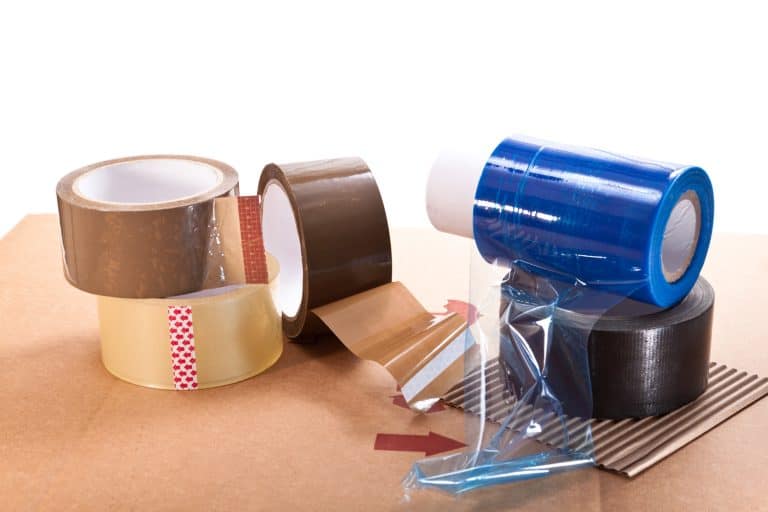 Cardboard for packaging, adhesive tape and nylon on a white background - Why regular packaging tapes do not stick during cold weather