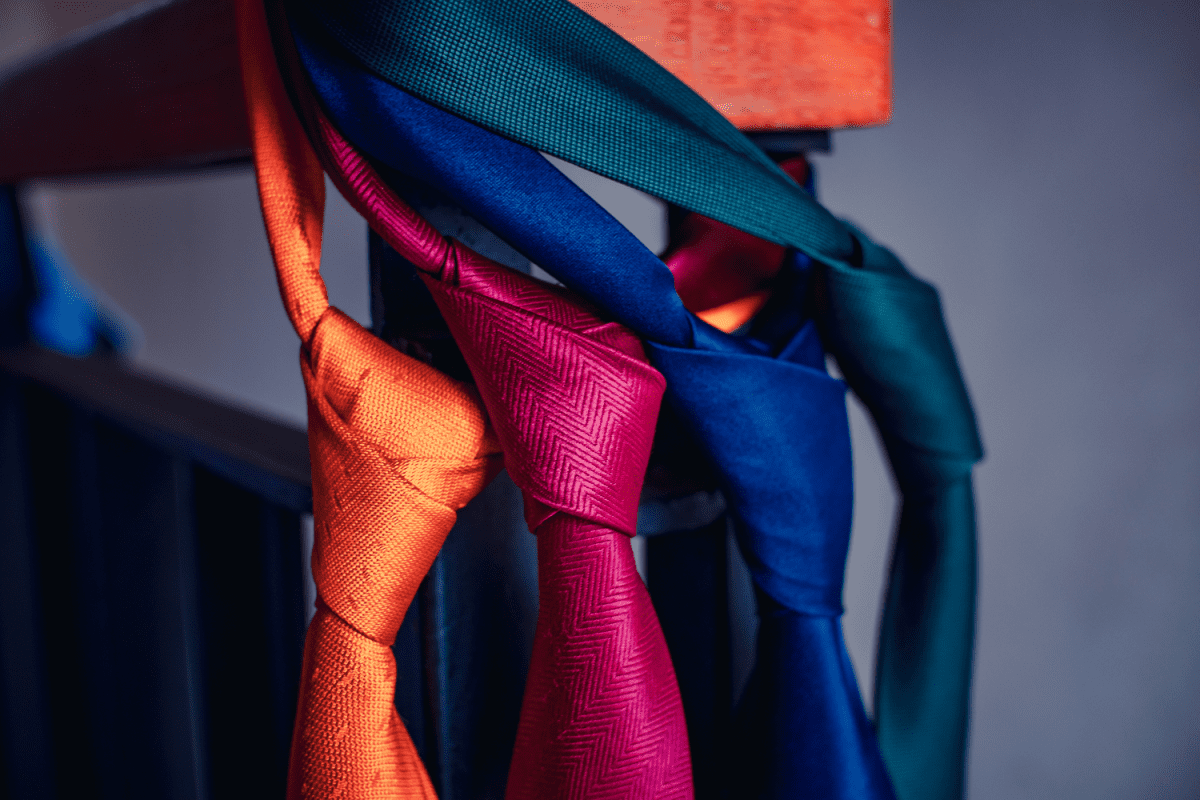 Colorful ties, ready to wear, hang at the end of the handle.


