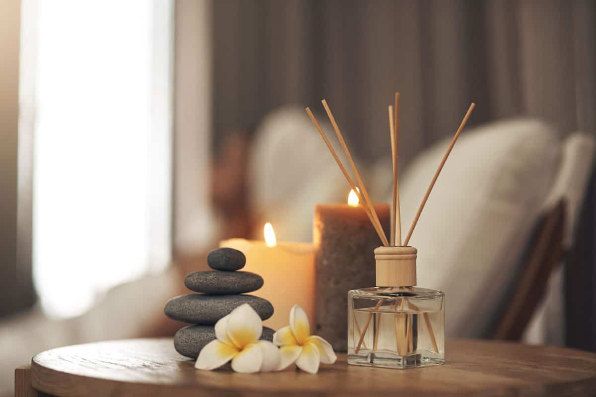 Scented candles, orchids, hot rocks inside a relaxation spa