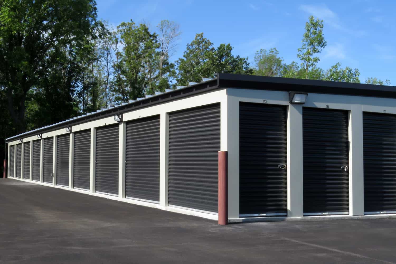 Self storage units with black garage doors for people who may need temporary or long term storage of their possessions.