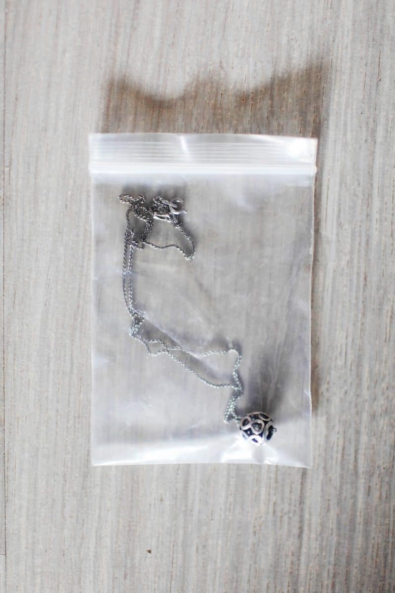 Silver pendant in ziplock, material evidence 