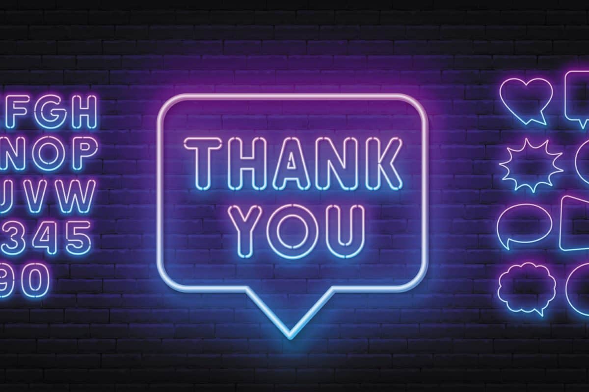 Thank you neon sign on brick wall background.
