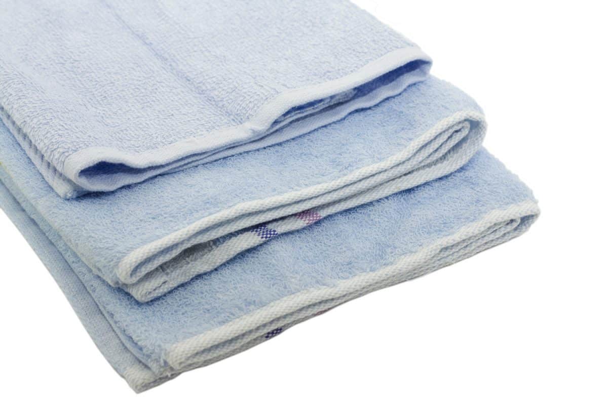 Three blue towels on a white background
