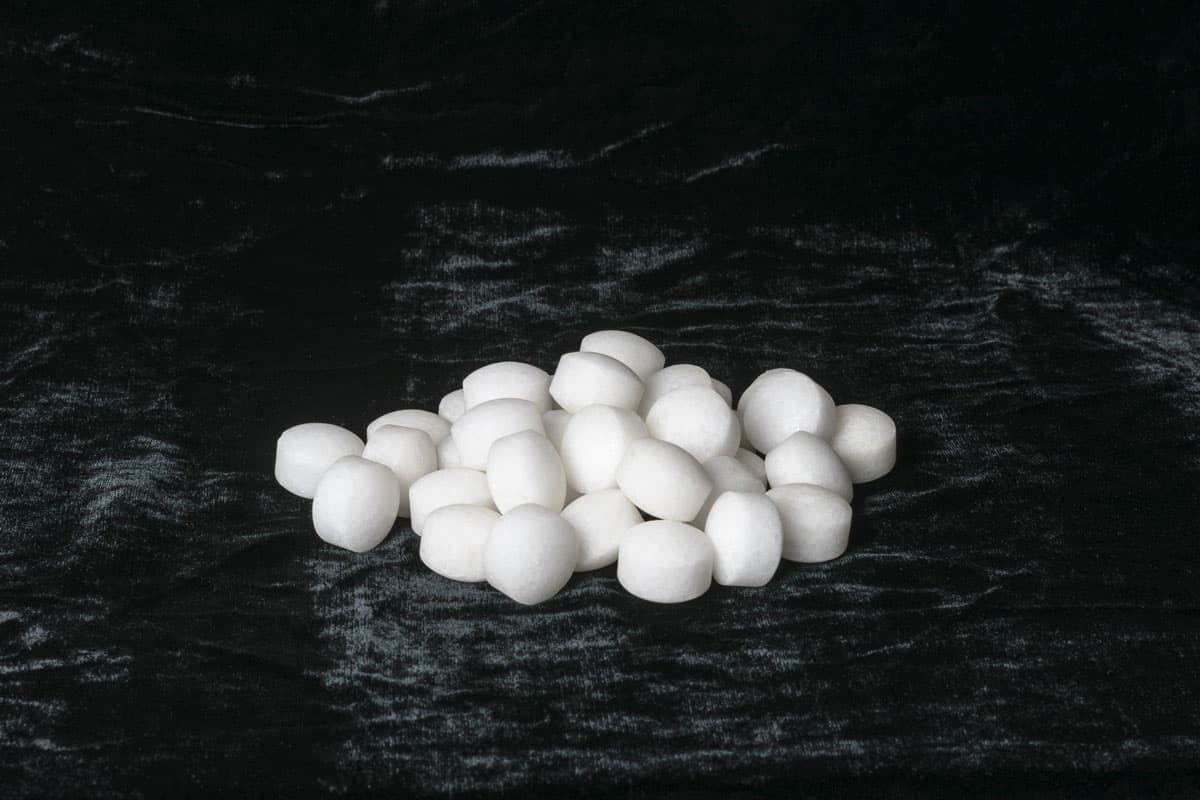 White naphthalene balls on black velvet
