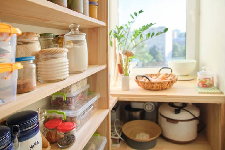 Wooden shelves with food and utensils, kitchen appliances in the pantry, What's The Best Material For Pantry Shelves?