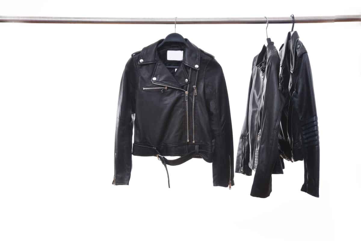 fashion three black leather punk jacket hanging isolated on hanger
