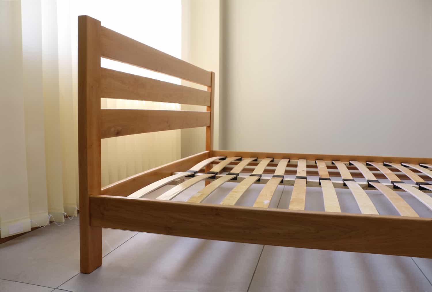 frame of a simple lacquered bed made of wood with slats