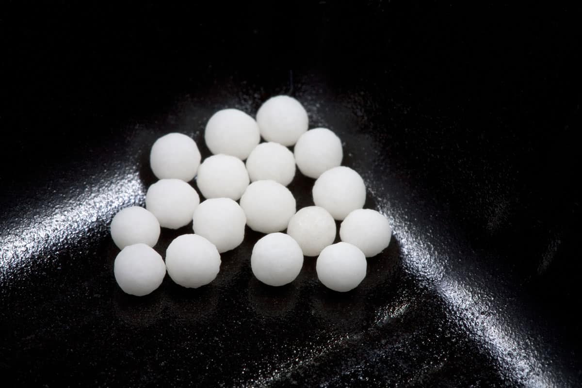 sugar homeopathy balls in black container