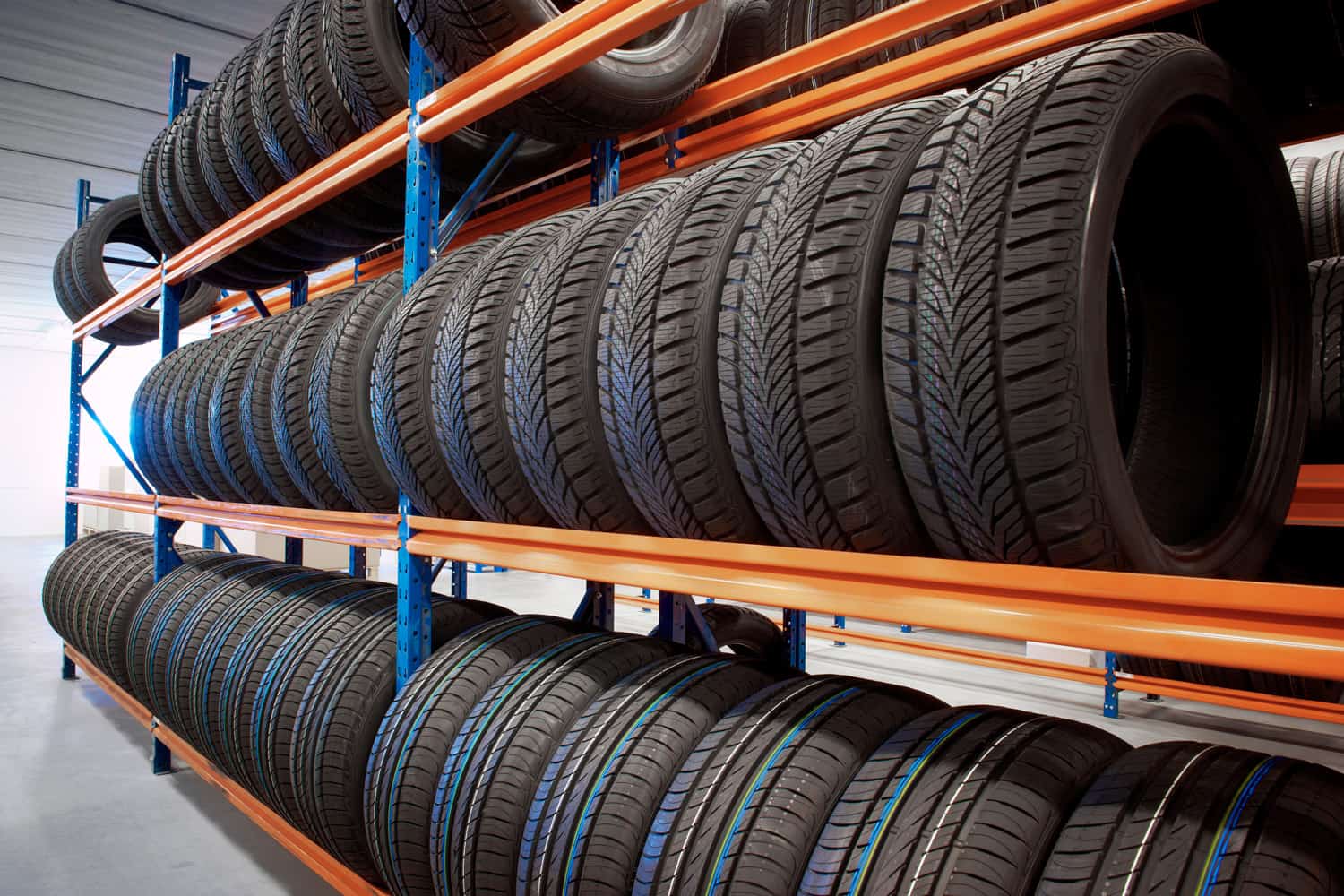 warehouse storing car tyres in rows for sale